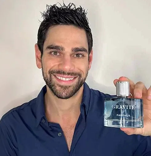 Kyle holding a Gravité fragrance bottle